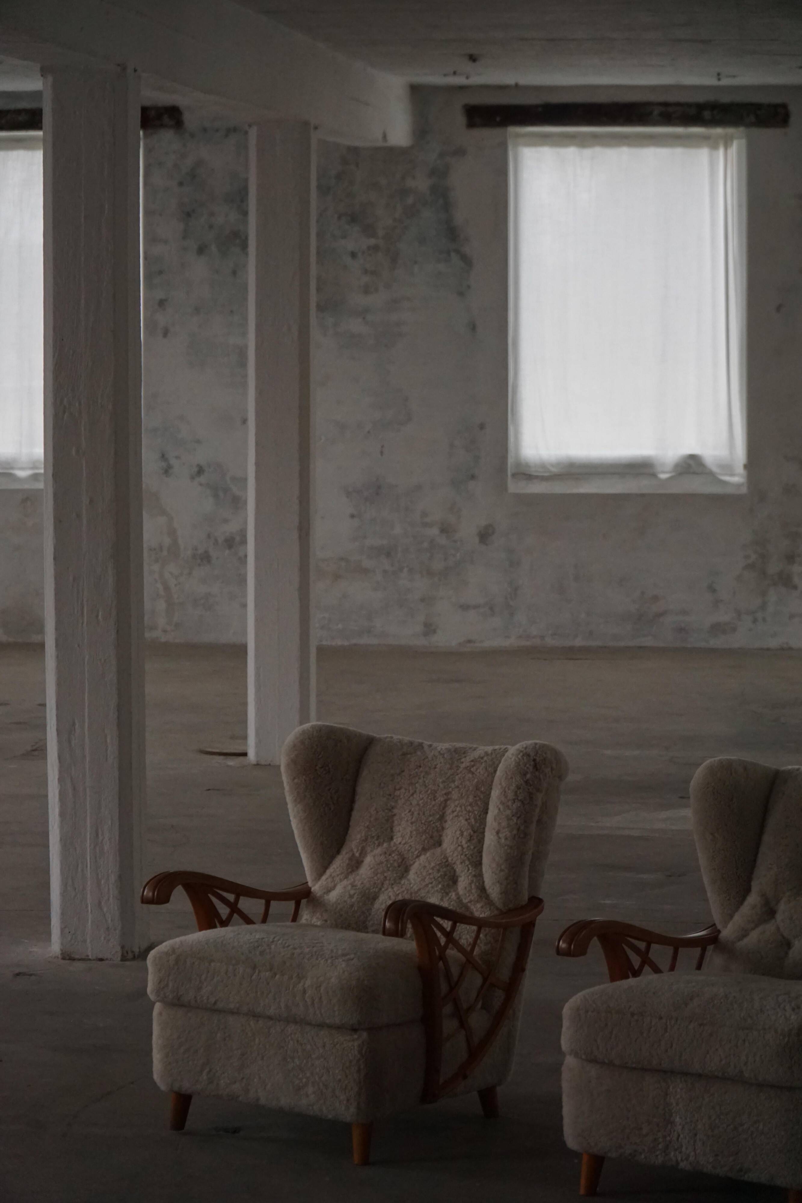 Pair of modern Swedish lounge chairs, shearling sheepskin and elm, 1940s.