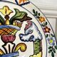 Decorative ceramic plate with griffins