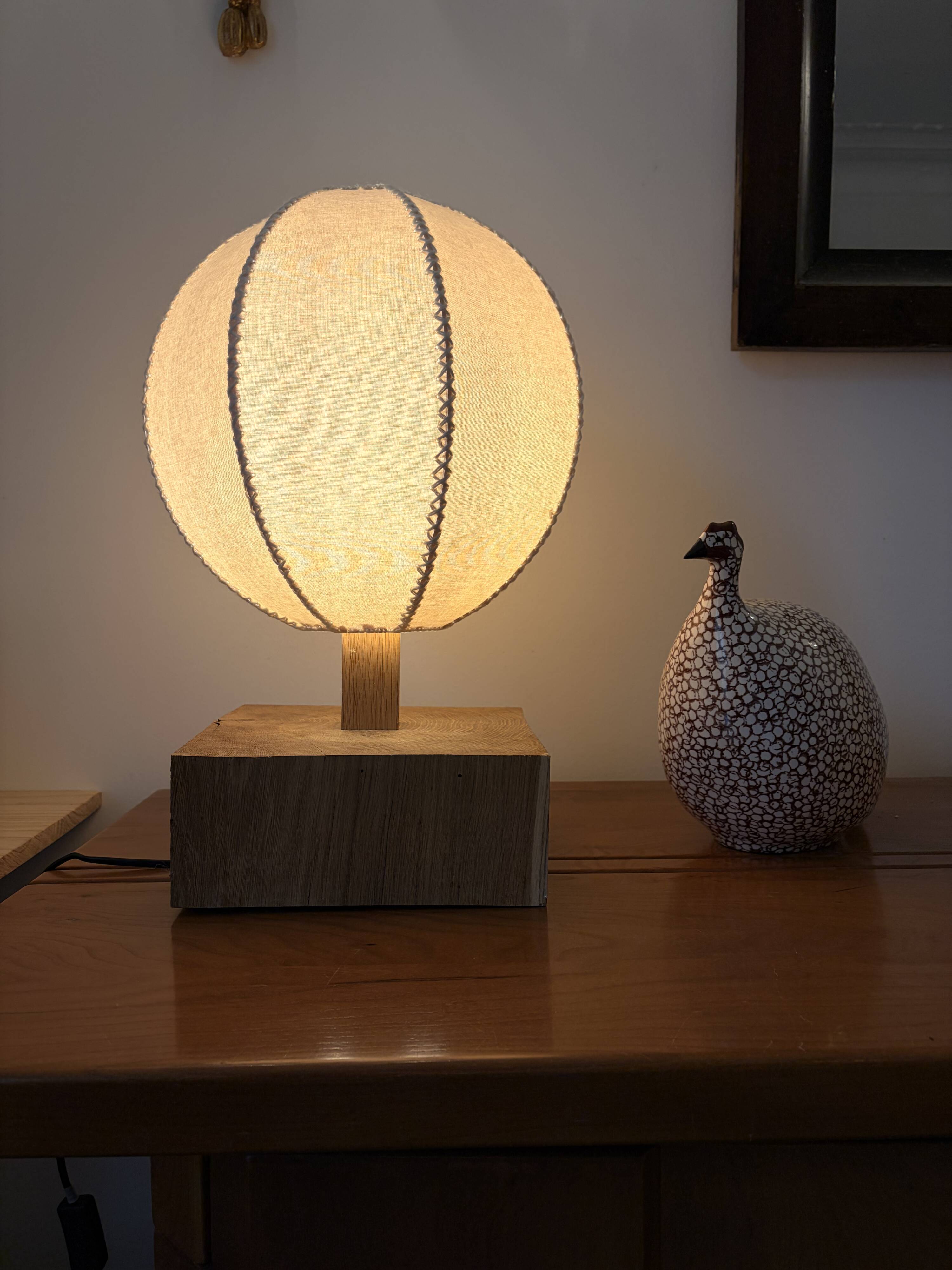 Handmade wooden ball lamp on a stand