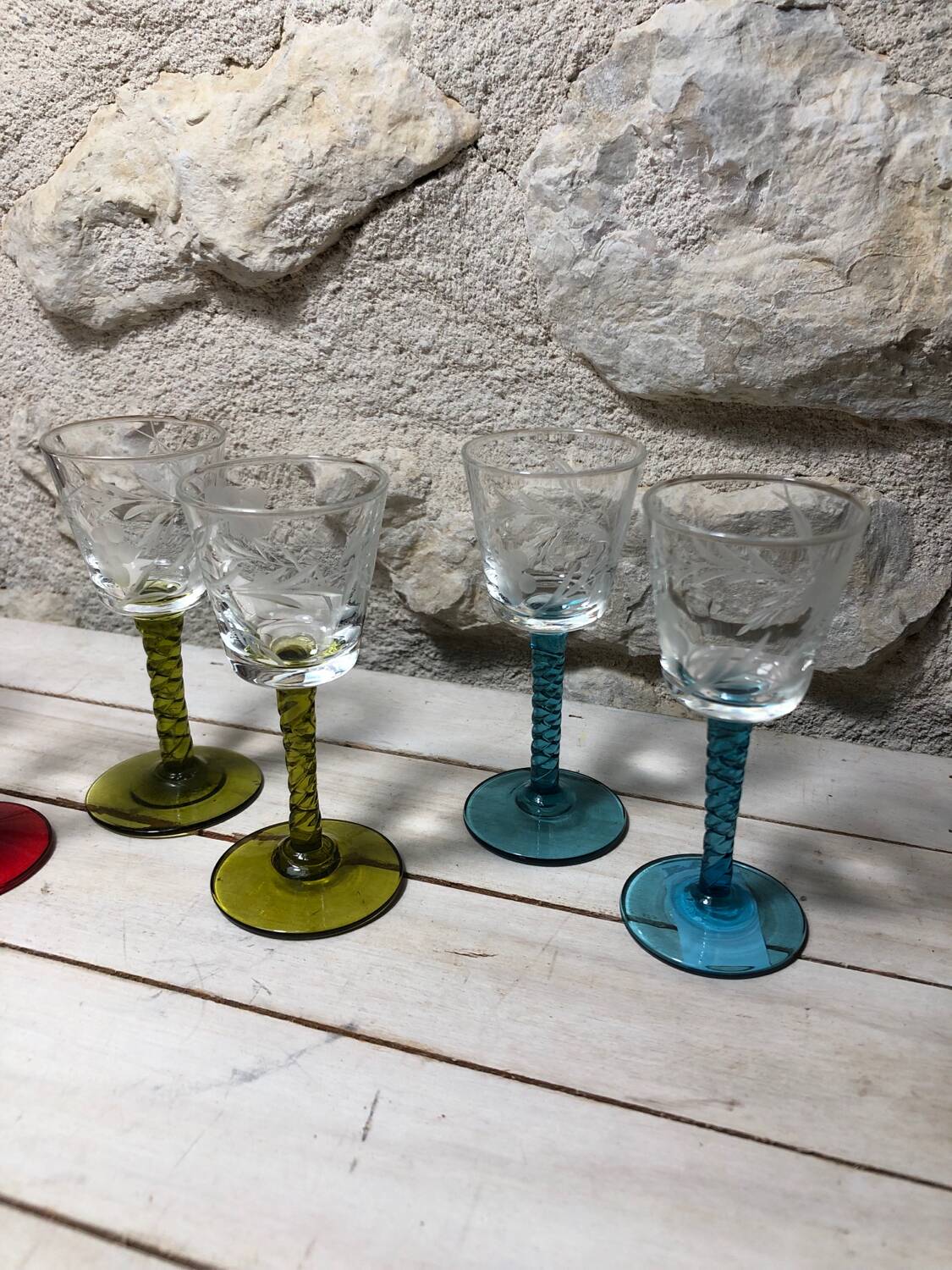 Antique and rare! Sold in a set of 12 colorful twisted stemmed glasses engraved with flowers and leaves
