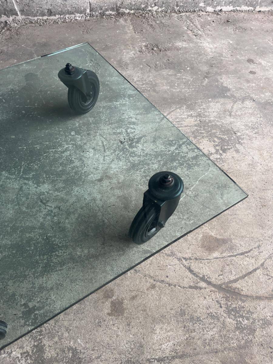 Gae Aulenti coffee table for Fontana Arte, transparent glass top with black cast iron supports, 1980s.