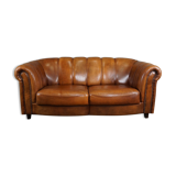 Sheepskin sofa with decorative nails