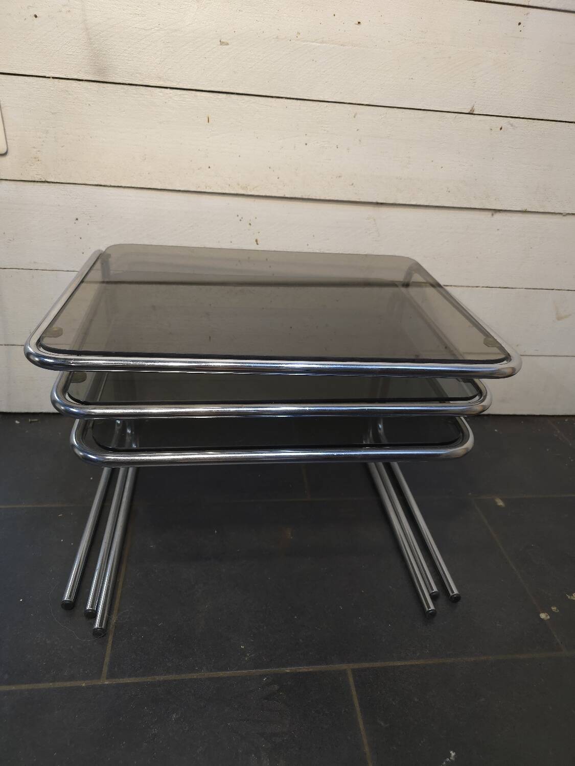 Nesting tables in chromed metal with smoked glass tops from the 1970s