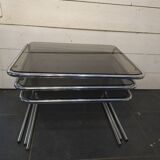 Nesting tables in chromed metal with smoked glass tops from the 1970s