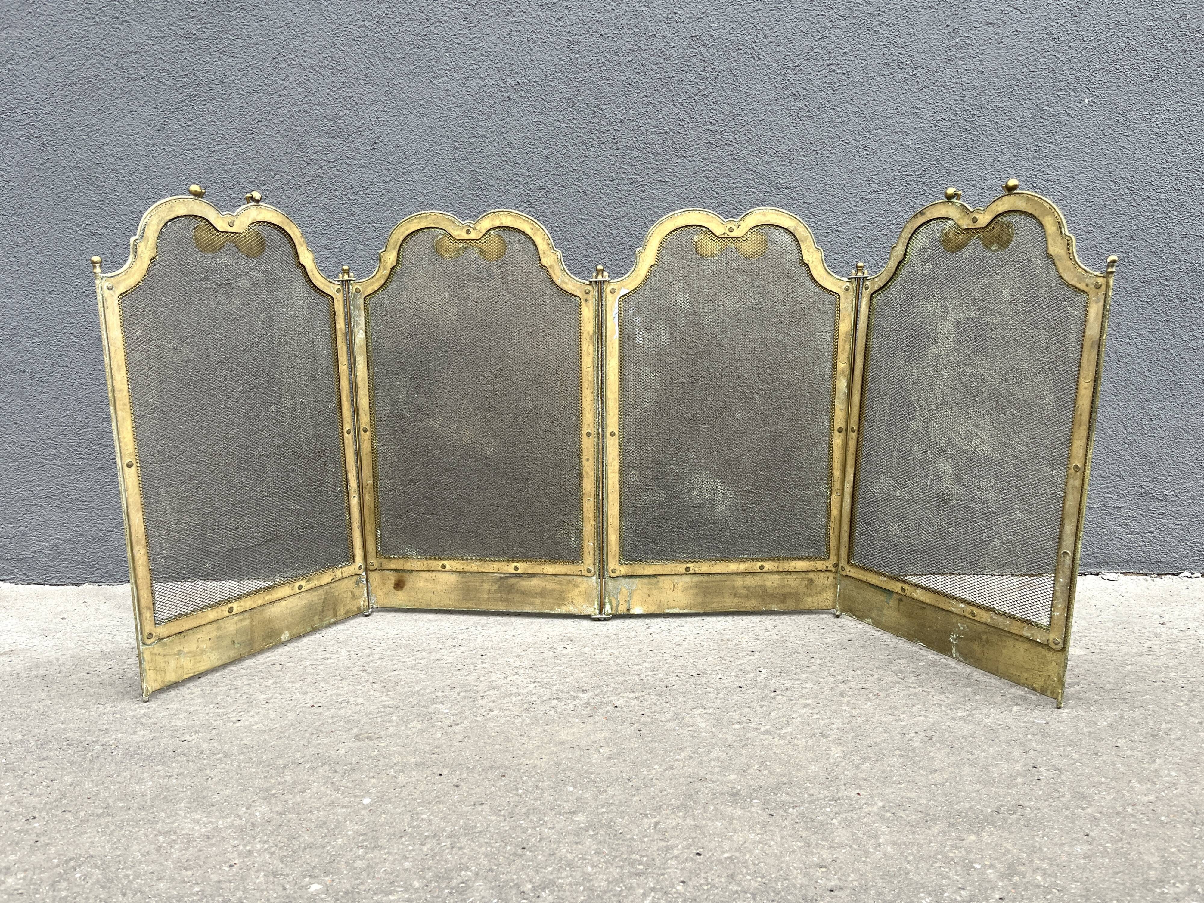 Antique brass fireplace screen from 1920, vintage spark guard.