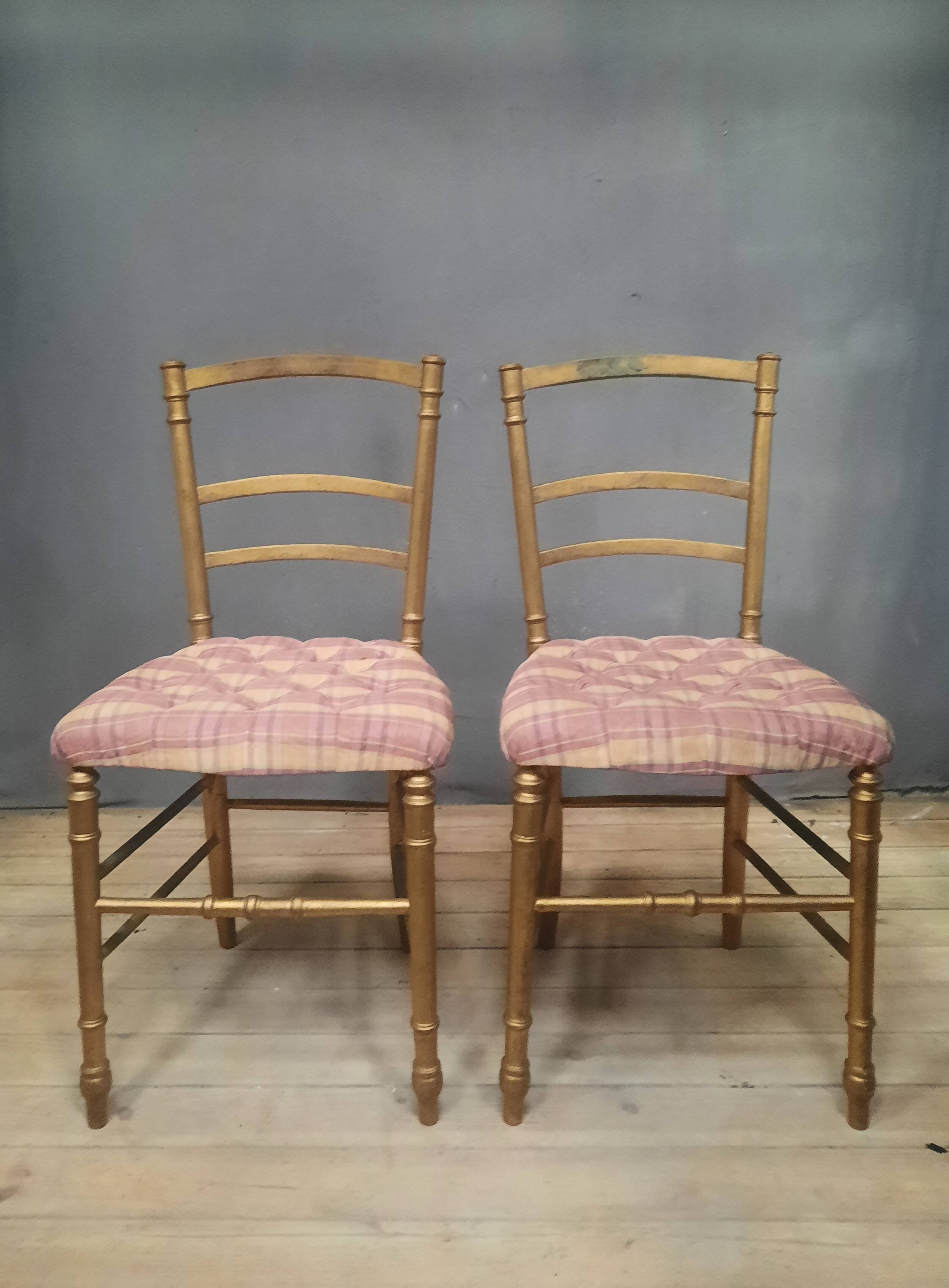 Pair of upholstered chairs in gilded wood
