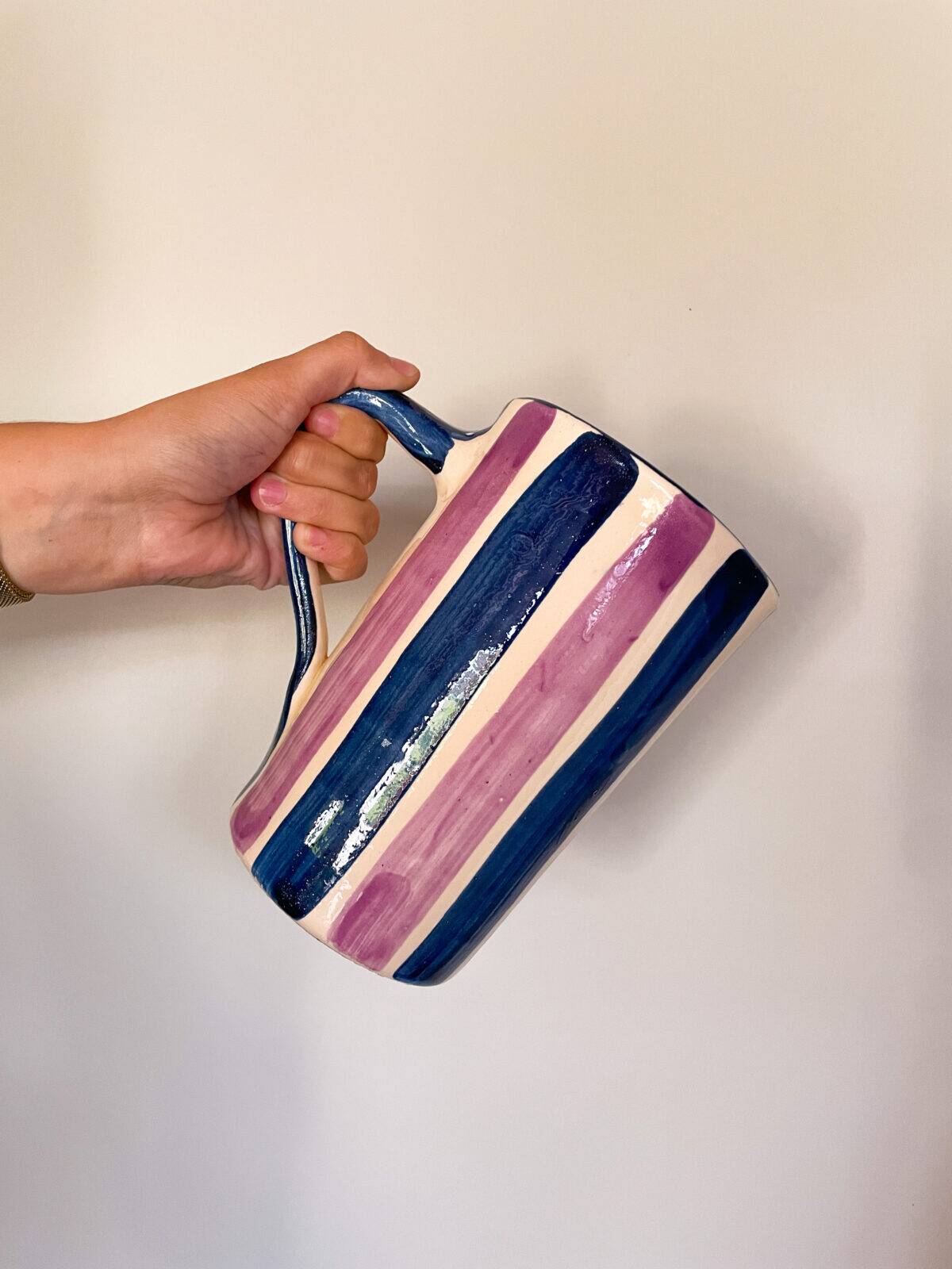 Blue and purple striped ceramic pitcher