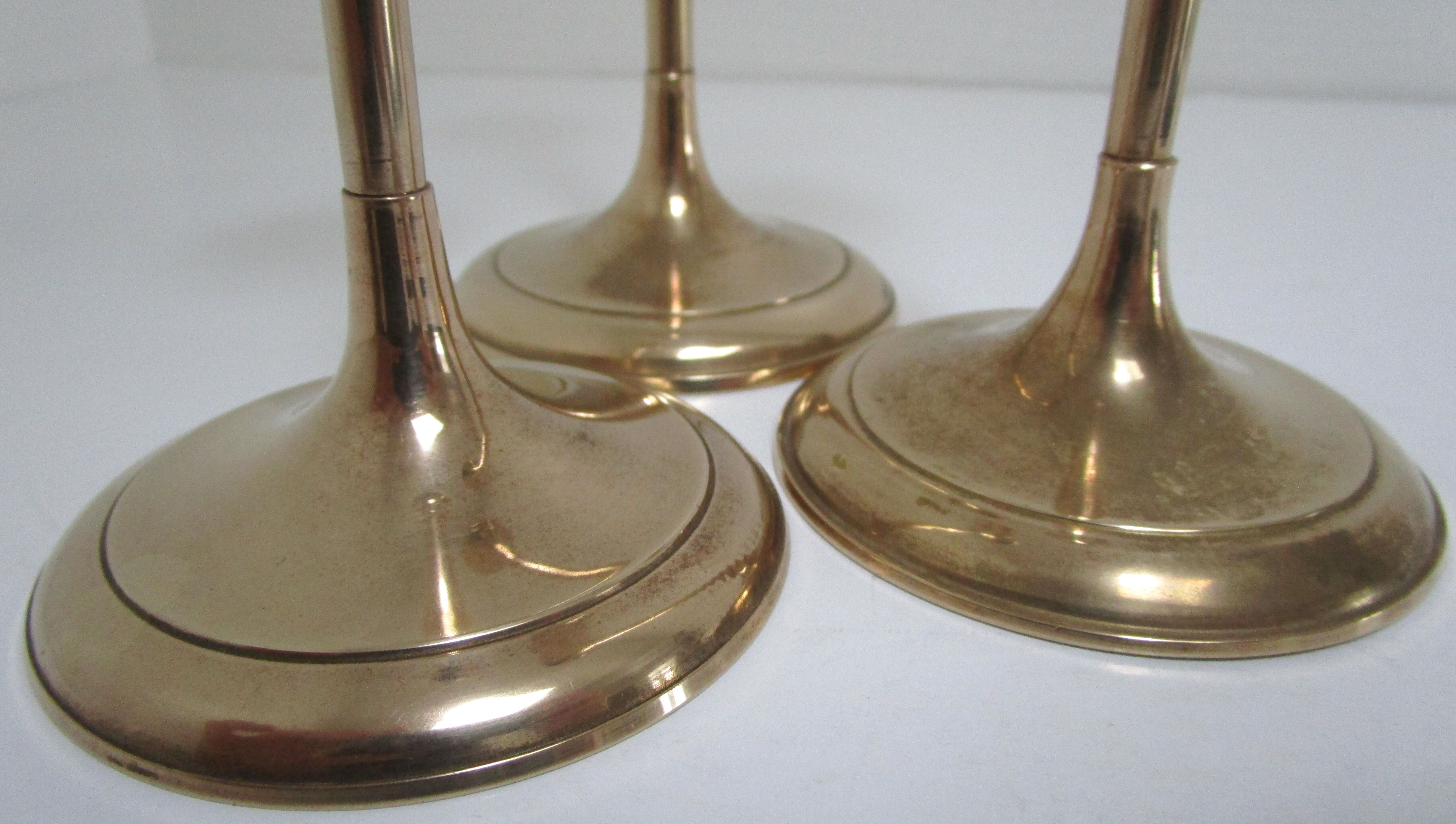 Trio of brass scandinavian candlesticks