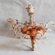 Wall lamp in antique cast iron with bird and scroll decorations.