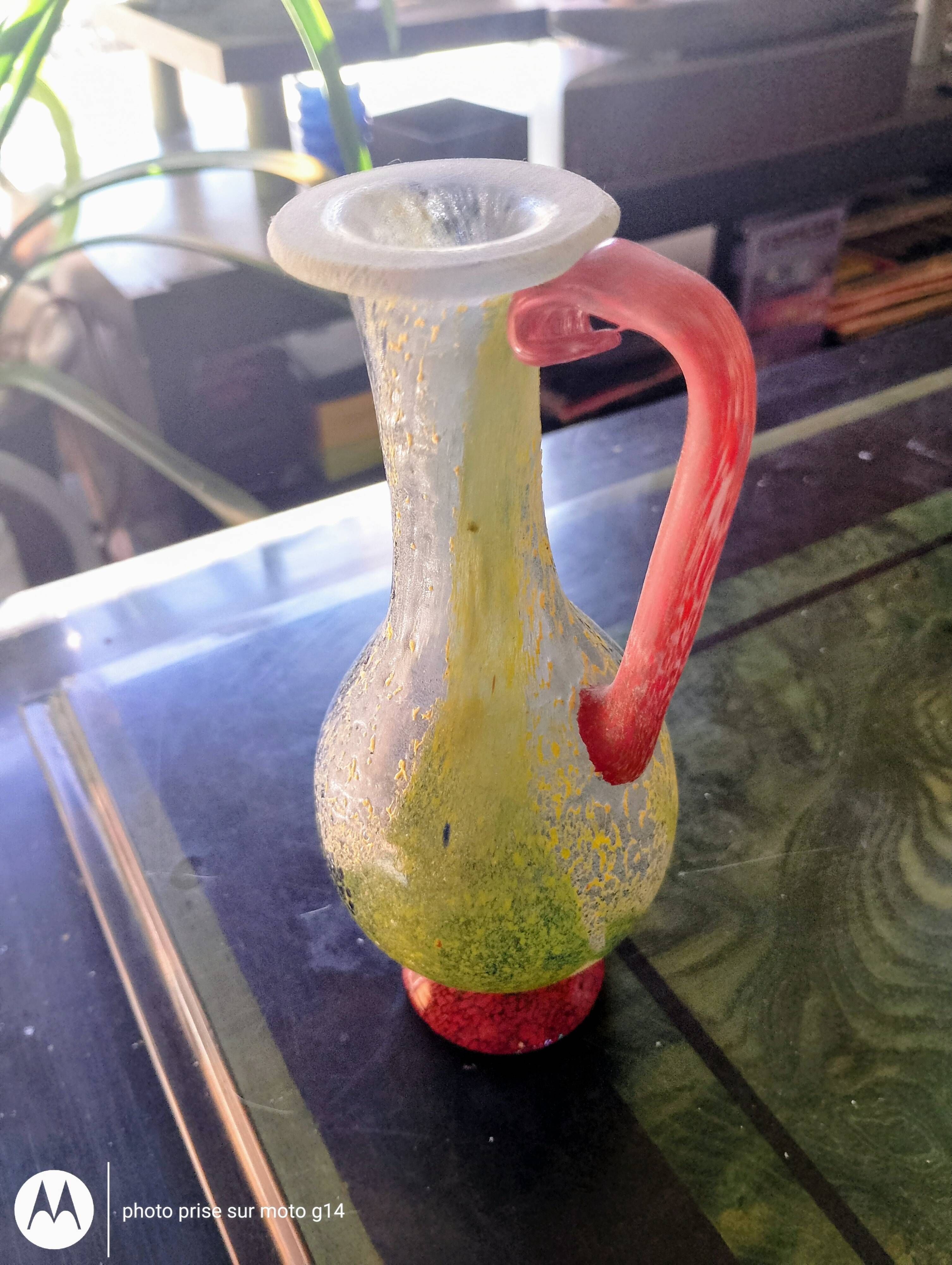 Small vintage glass vase with a red handle – Speckled green and yellow decoration