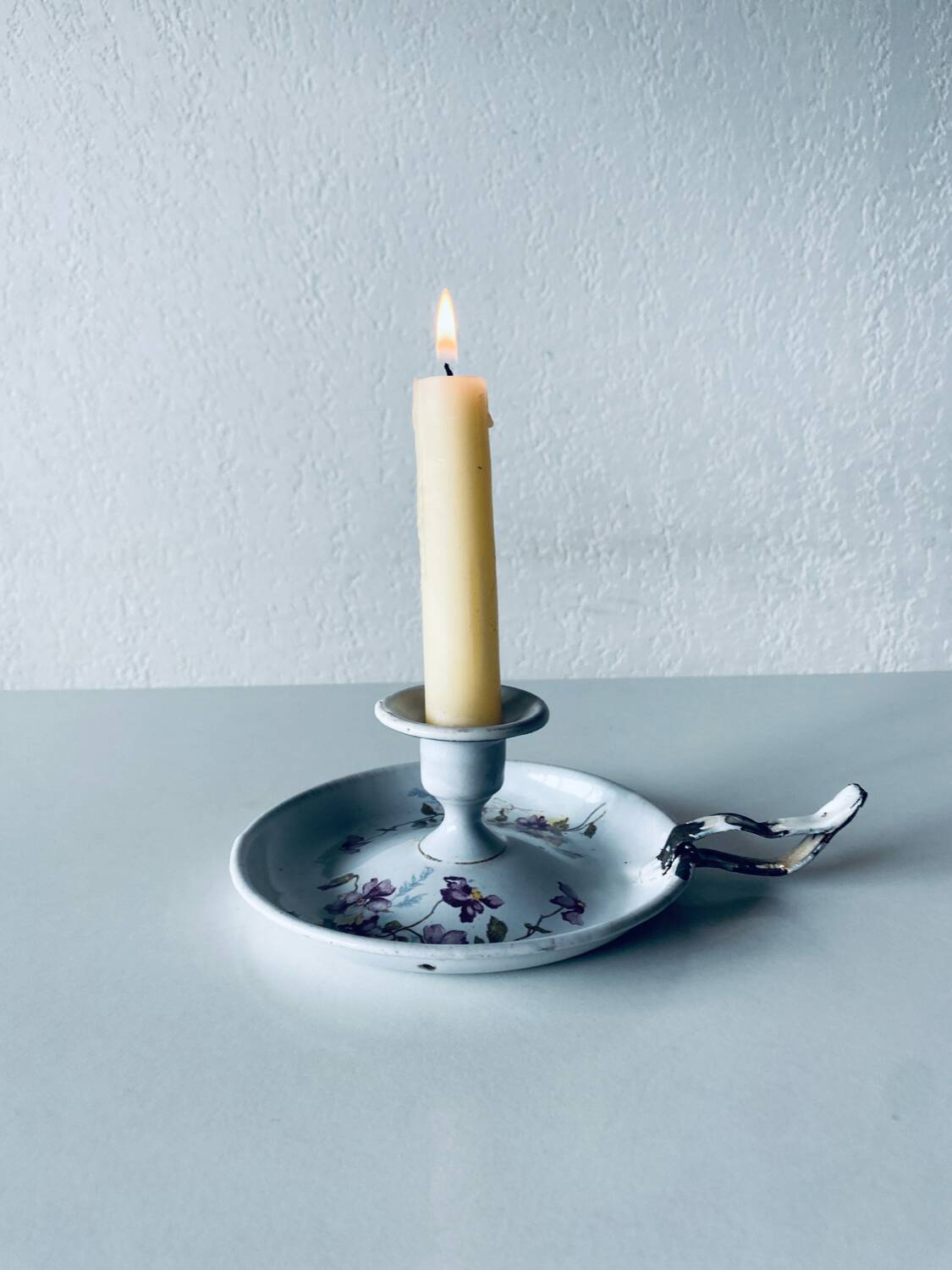 Antique enamelled metal candle holder