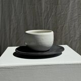 White Indonesian ceramic cup and gray saucer