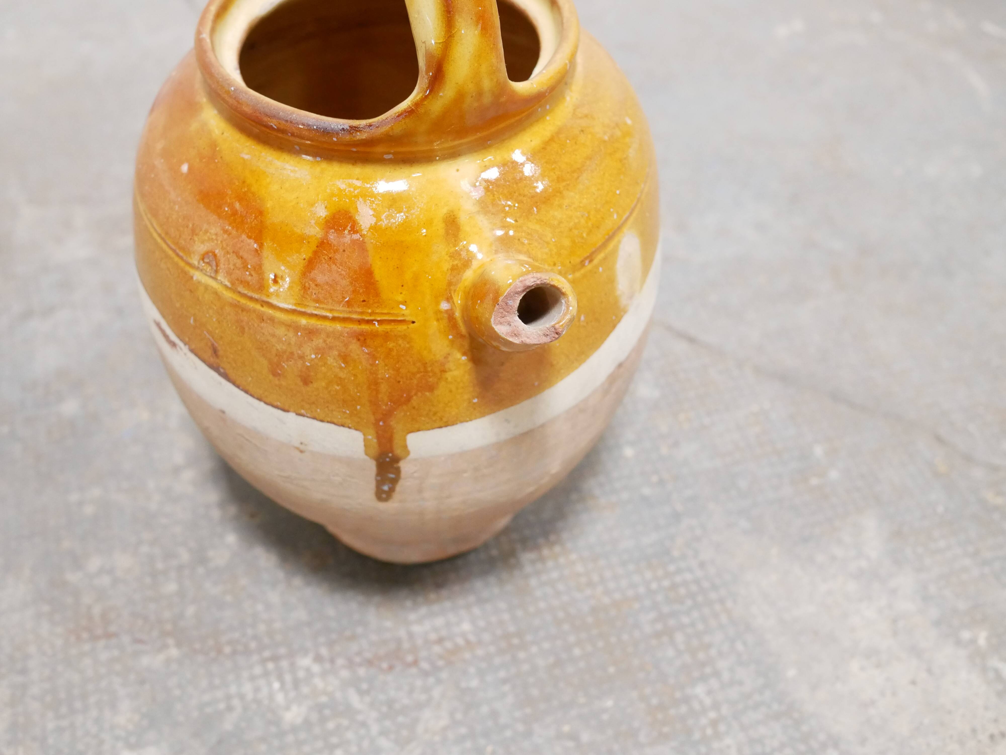 Old gargoulette pot in glazed terracotta