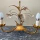 Golden metal chandelier decorated with flowers