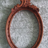 Oval frame with carved pediment