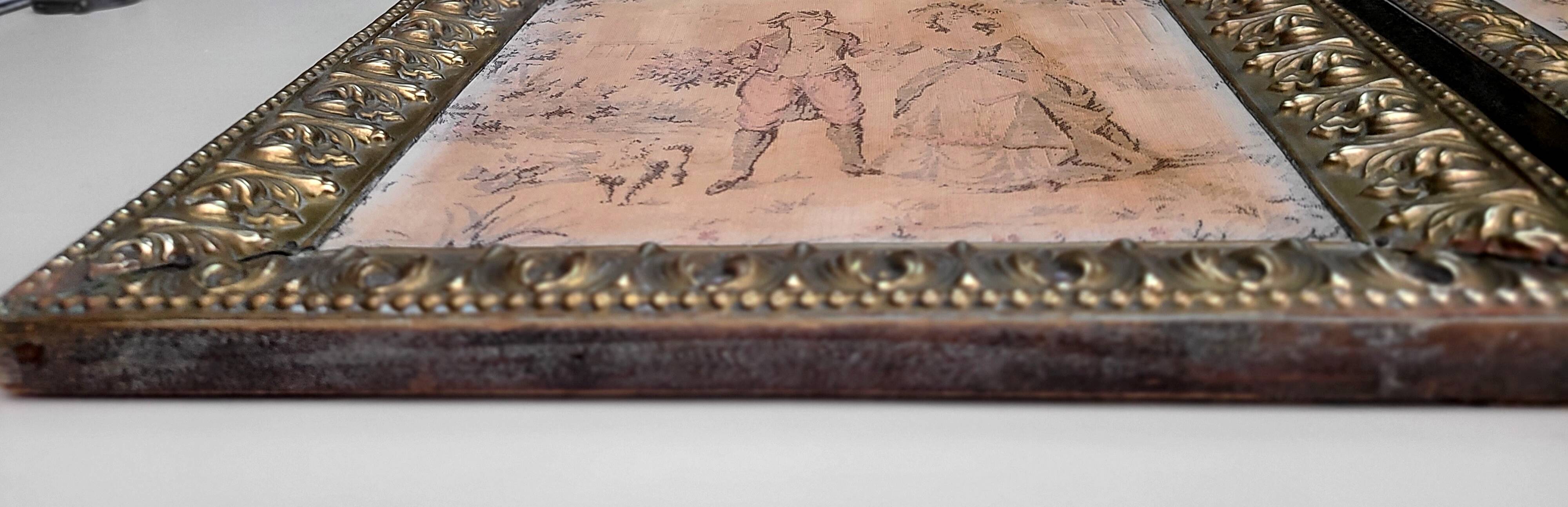 Antique tapestries framed in repoussé brass.