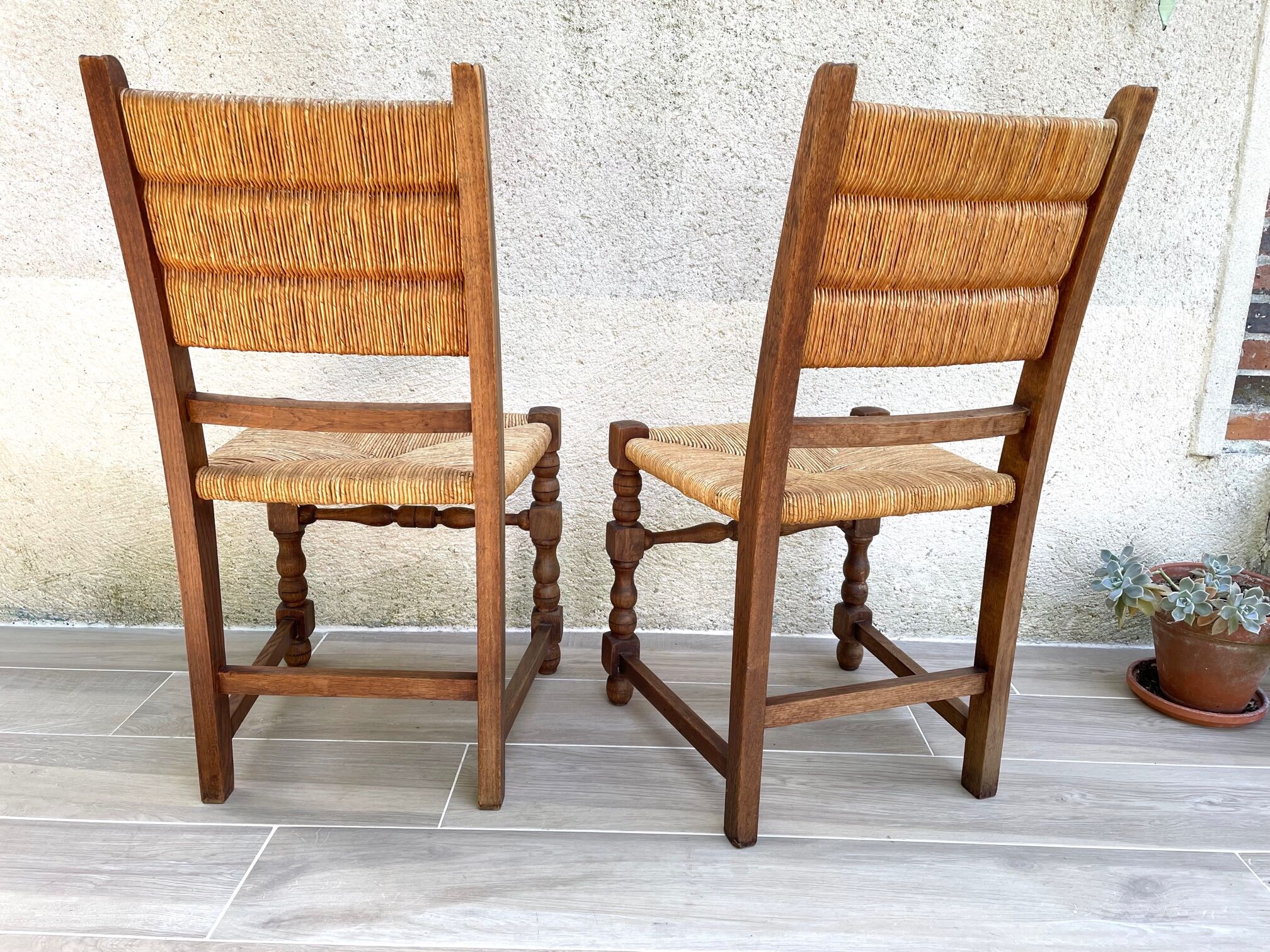 Pair of straw and solid oak chairs