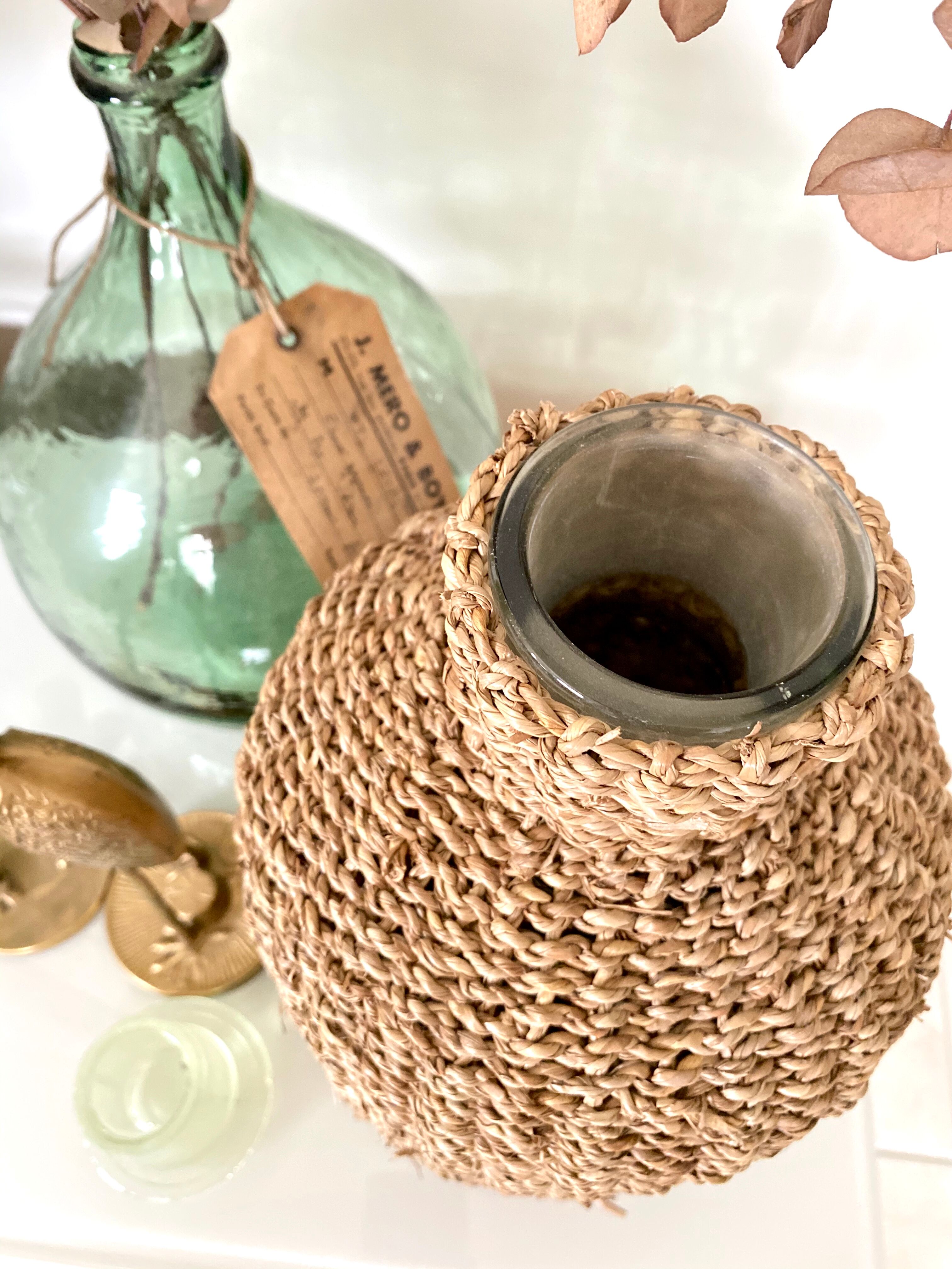 Glass bottle and braided rope