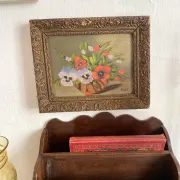Old painting of a bouquet of pansies and poppies.
