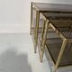 Suite de trois tables gigognes de style en laiton et verre fumé XX siècle