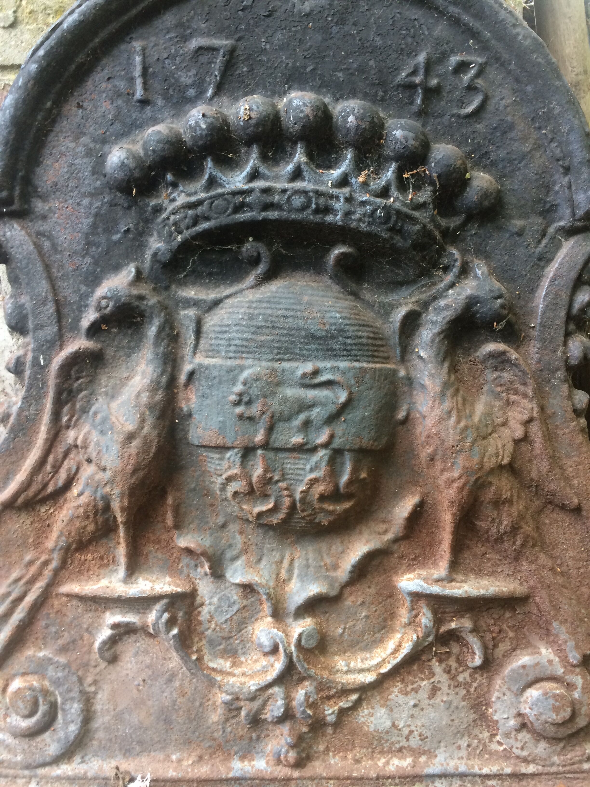 18th-century cast iron chimney plate - crowned lion coat of arms and birds