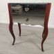 Glass art deco mirror beside table
