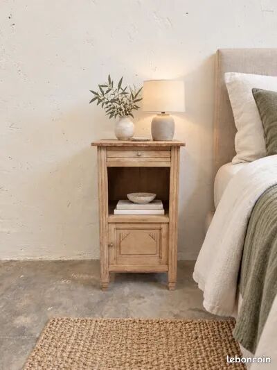 Antique wooden bedside table with a pink/orange marble top.