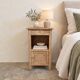 Antique wooden bedside table with a pink/orange marble top.