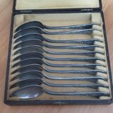 Many silver-plated metal teaspoons.