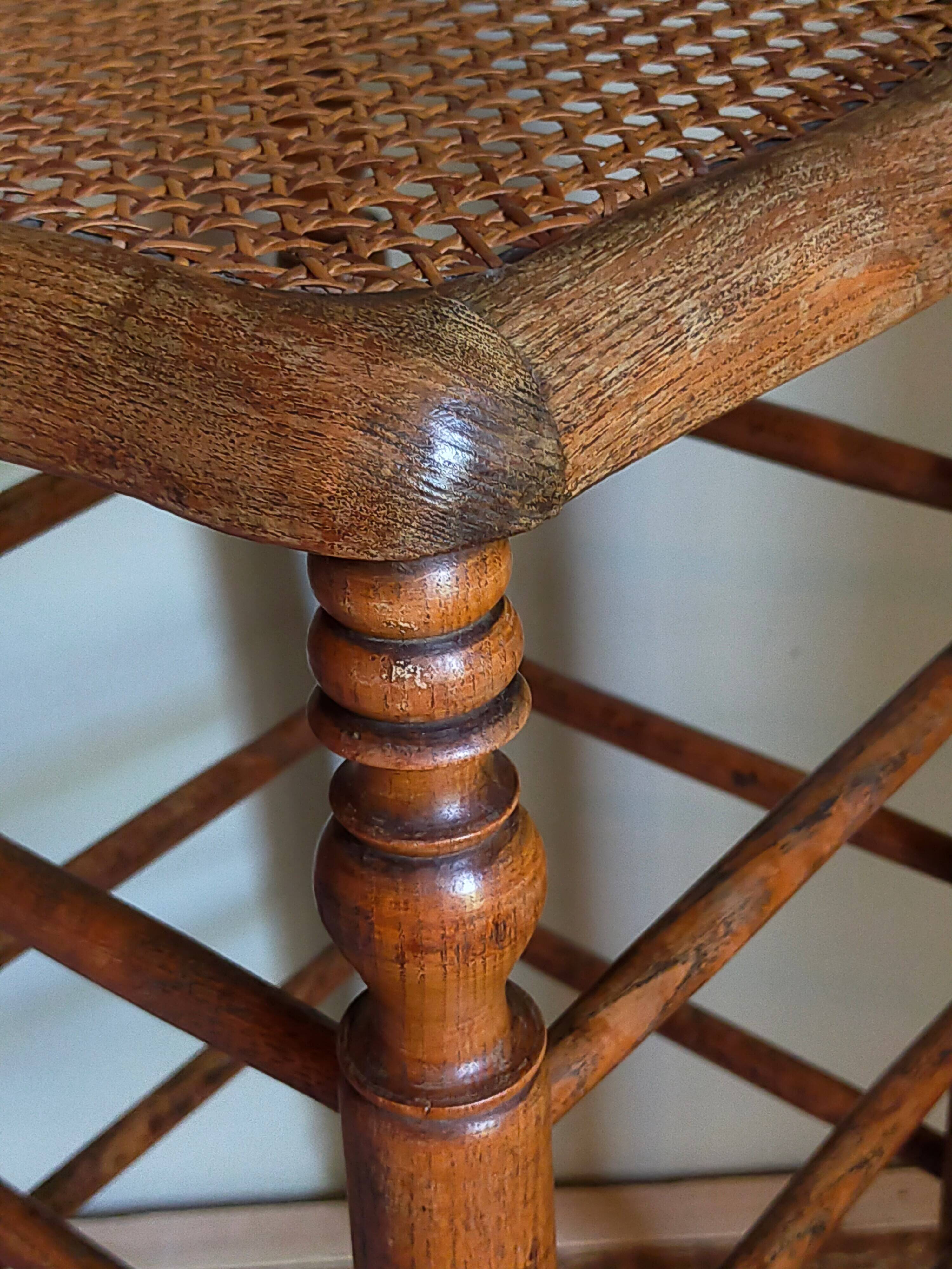 Antique stool with cane and turned wood