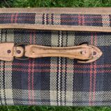 Old large suitcase in leather and tartan fabric