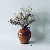 Old pitcher in glazed terracotta
