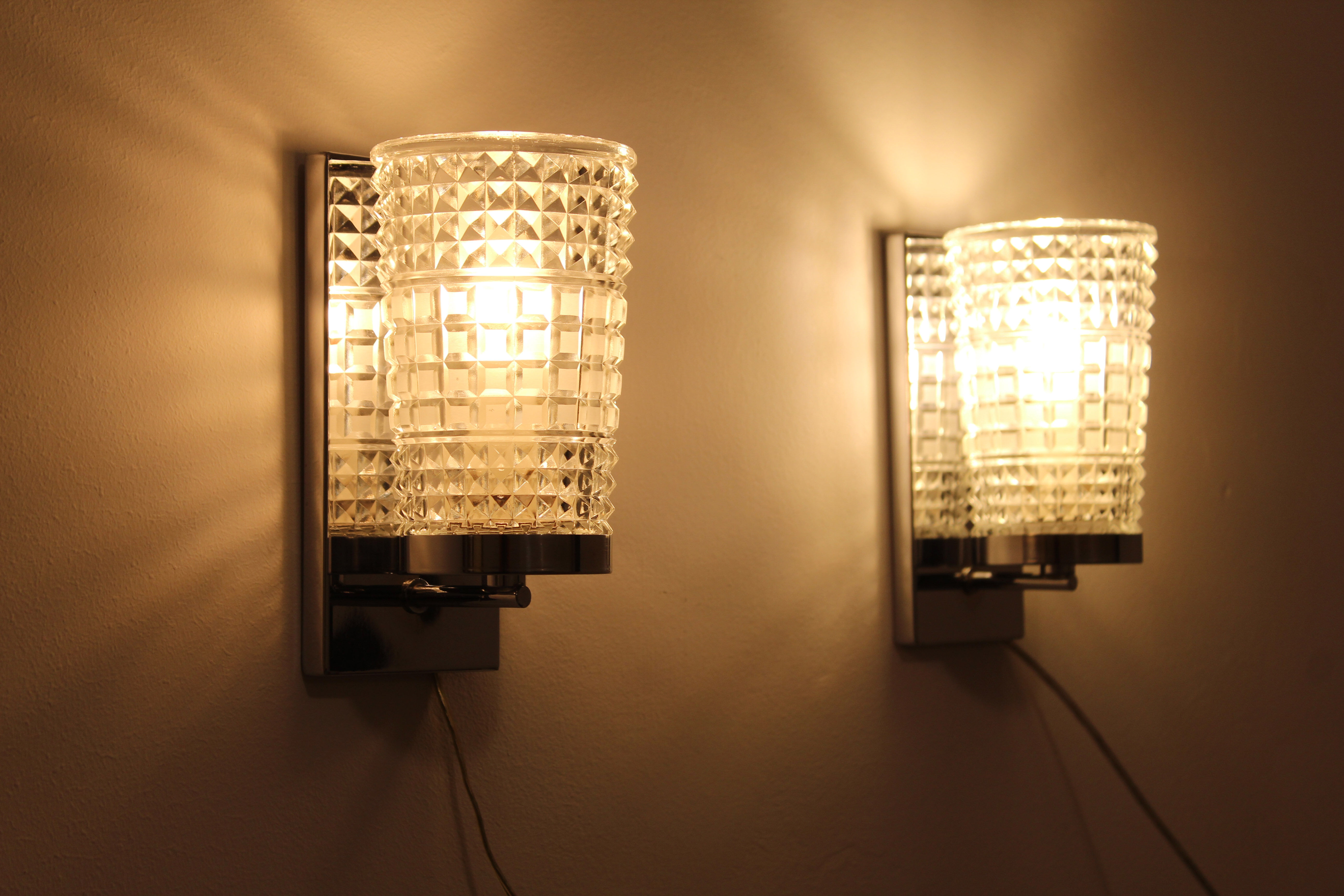 Wall lamps in worked glass and chromed metal, Italy 70's