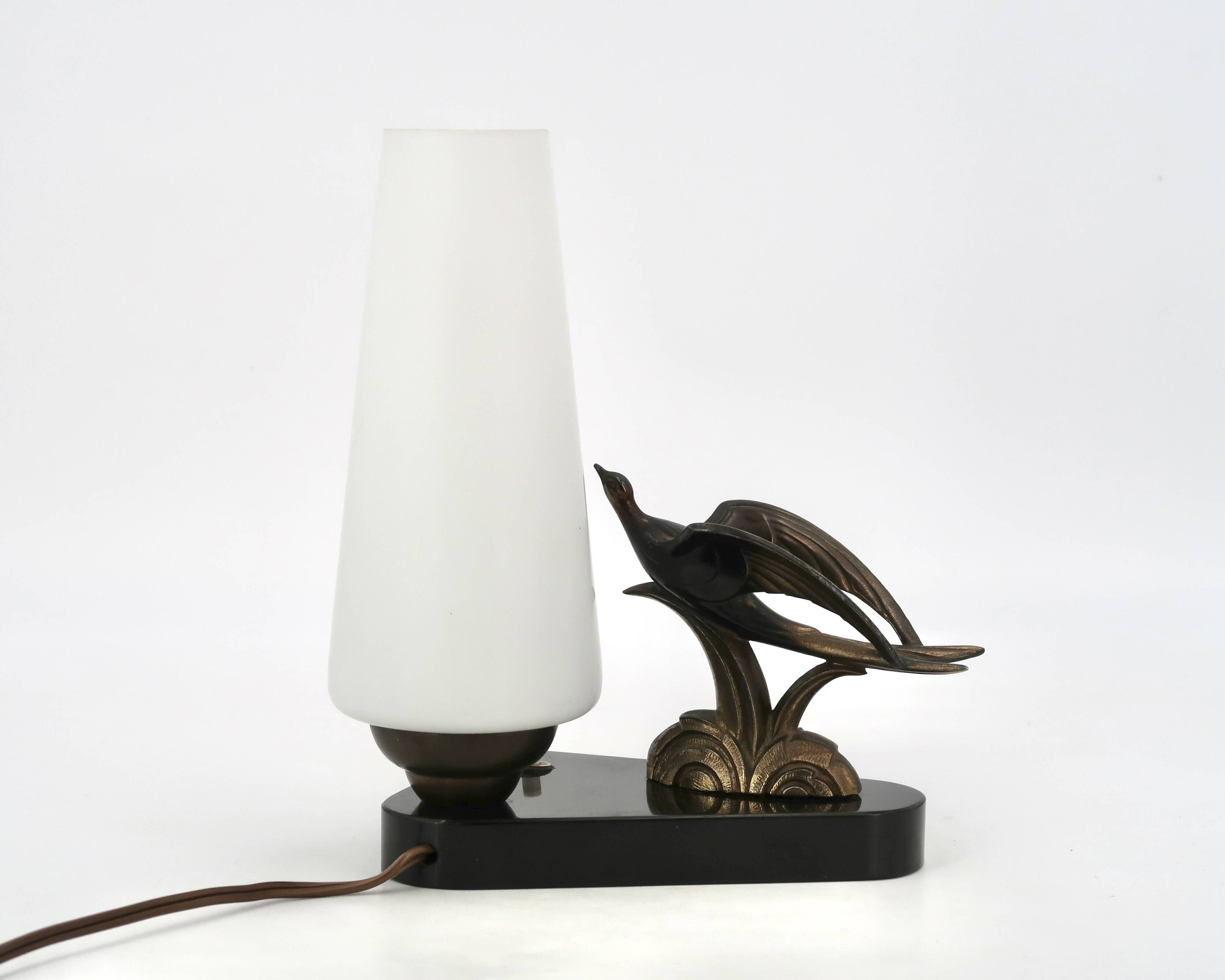 Art Deco lamp with swallow sculpture, marble base, opaque white globe.