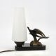 Art Deco lamp with swallow sculpture, marble base, opaque white globe.