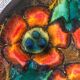 Enamelled sandstone plate with floral decoration