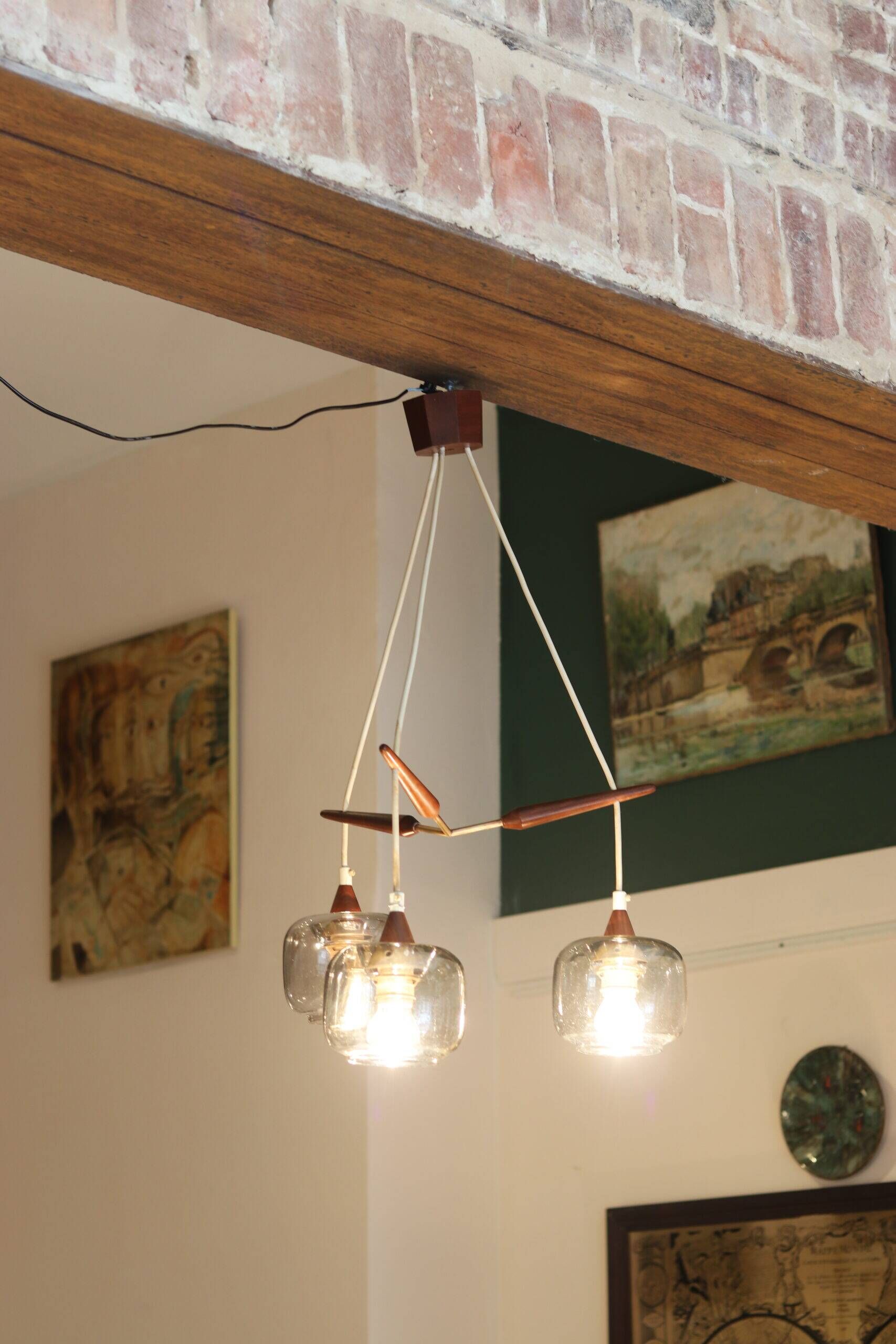 Scandinavian chandelier "Cascade" from the 1960s in brass, teak, and smoked glass.
