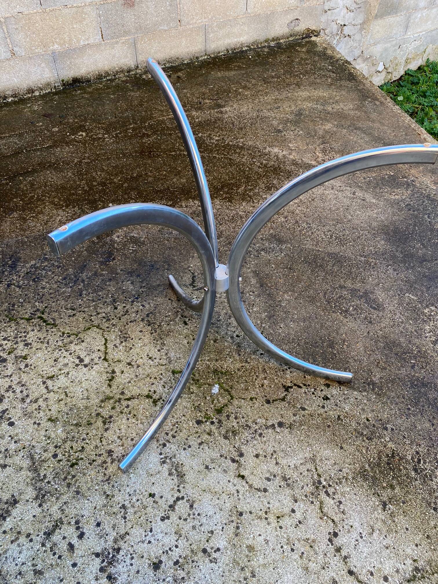 Table with chrome metal legs and smoked glass top.
