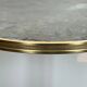 Round bronze side table with triple shelves of églomisé mirrors from Maison Baguès