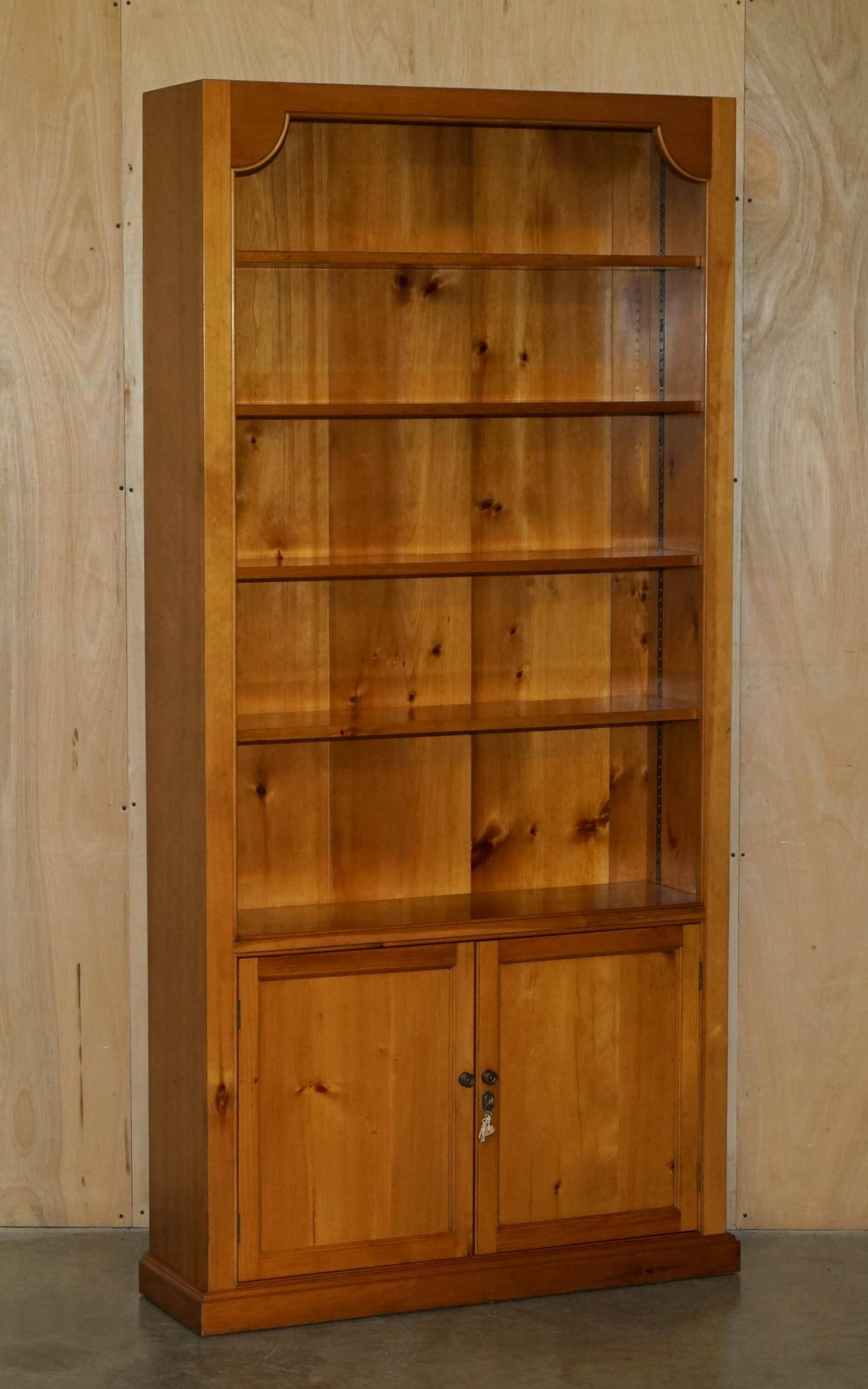 Pair of vintage cherry wood bookcases with lockable doors.