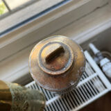 Gourd and vase in shell casing