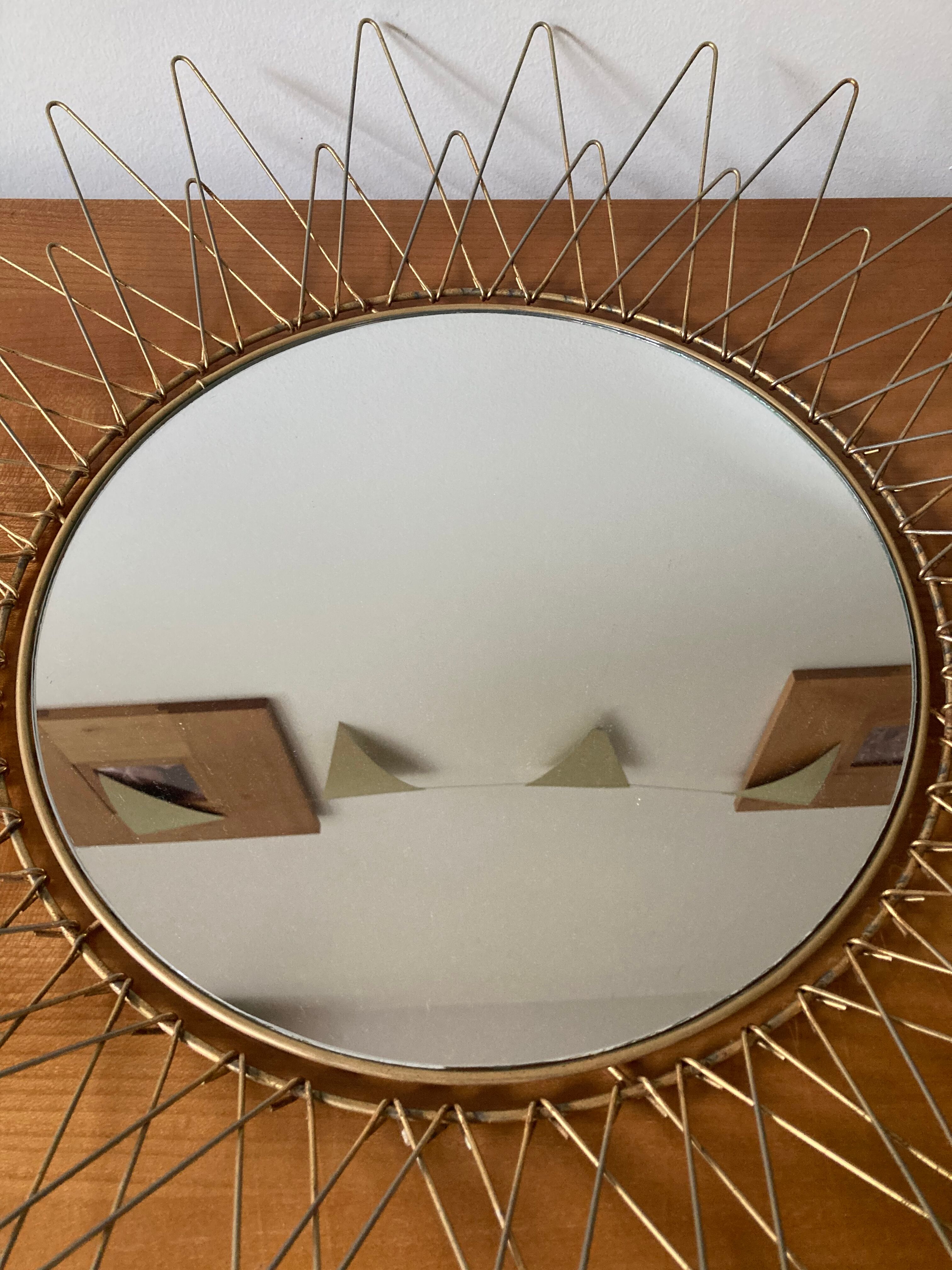 Sun mirror in gilded metal