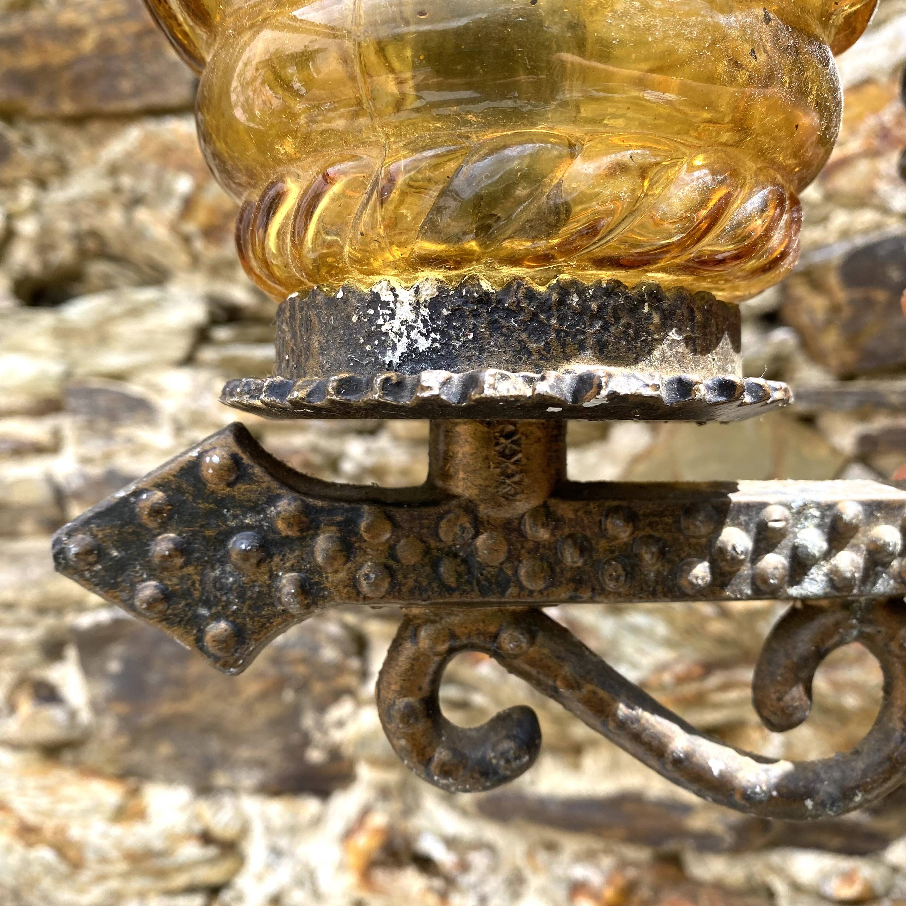Medieval style metal and amber glass wall lamp