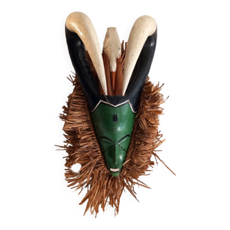 Old tribal mask in wood and raffia fiber