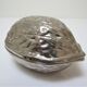 silver metal nutcracker in the shape of vintage walnuts