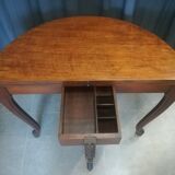 Half-moon mahogany game table on casters