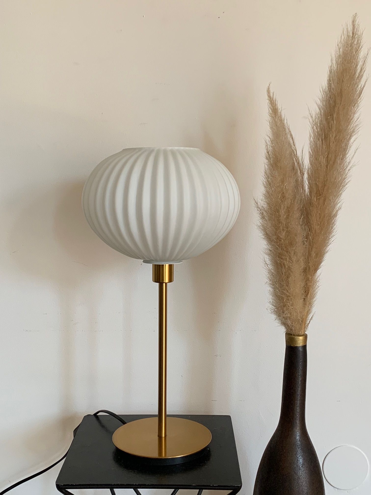 Table lamp with an antique white opaline lampshade and a vintage golden foot