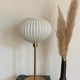 Table lamp with an antique white opaline lampshade and a vintage golden foot