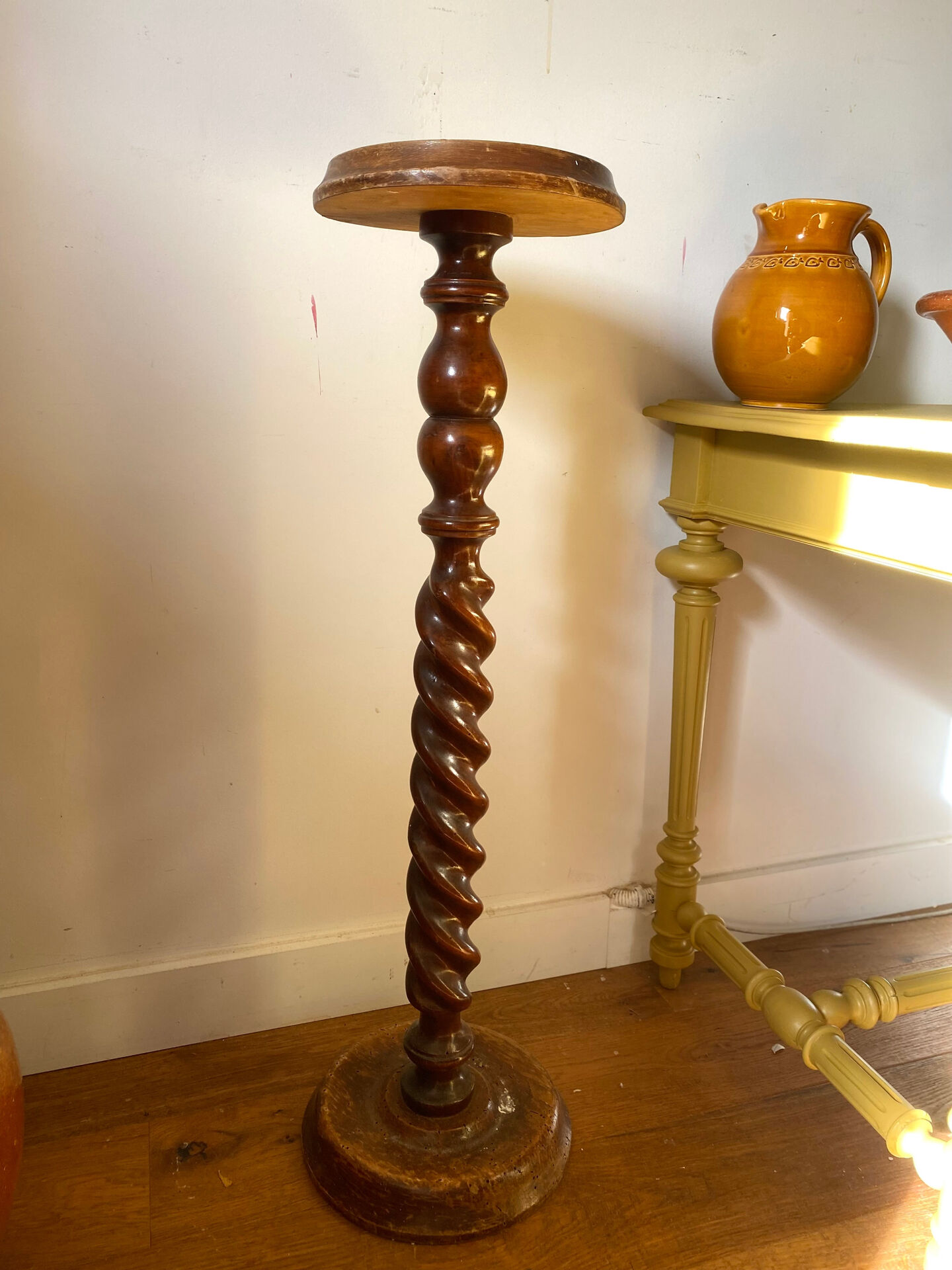 Antique pedestal table with a twisted column.