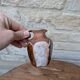 Old small pitcher in glazed terracotta